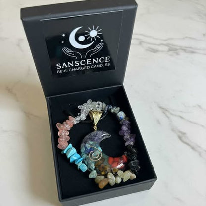 Colorful beaded bracelet with a pendant in a 'Sanscence' box on a white surface
