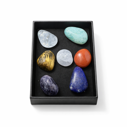 Set of colorful stones in a black box on a white background
