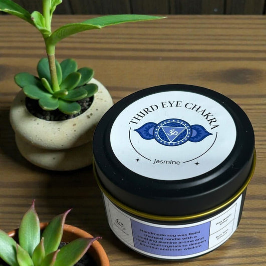 Jar of product with a label next to two potted plants on a wooden surface
