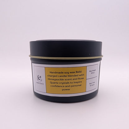 Handmade soy wax candle in a black container with a label on a white background