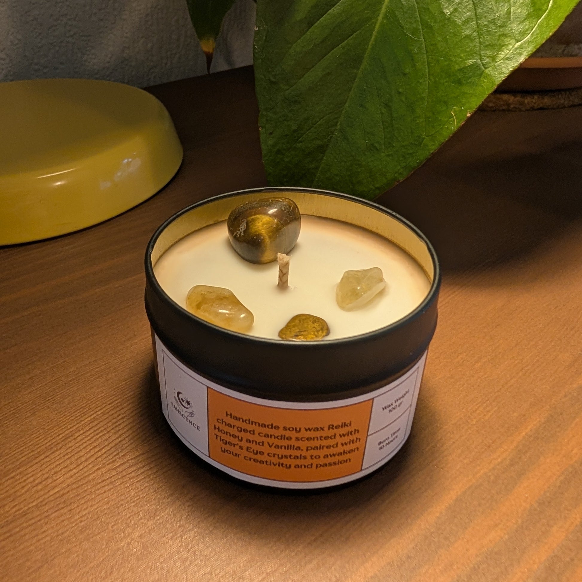Candle in a jar with decorative elements on a wooden surface