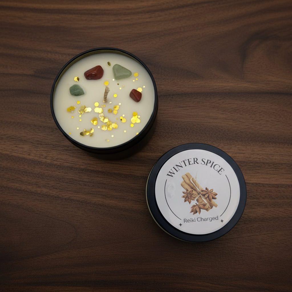 Candle with decorative stones and glitter, labeled 'Winter Spice', on a light gray background