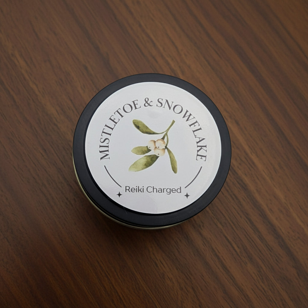 Candle tin labeled 'Mistletoe & Snowflake' with a white background