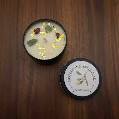 Candle with decorative elements and a branded lid on a light gray background