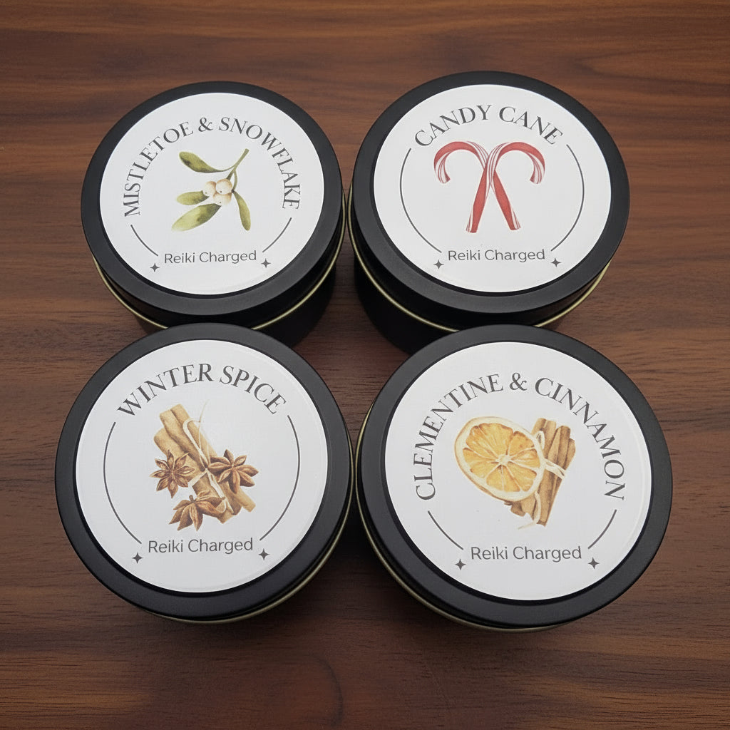Four tins with labels featuring different scents on a light gray background