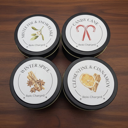 Four tins with labels featuring different scents on a light gray background
