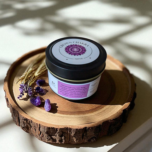 Crown Chakra candle on a wooden surface with lavender flowers