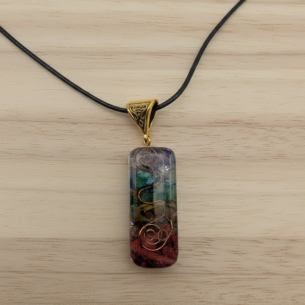 Multicolored pendant on a black cord against a light gray background