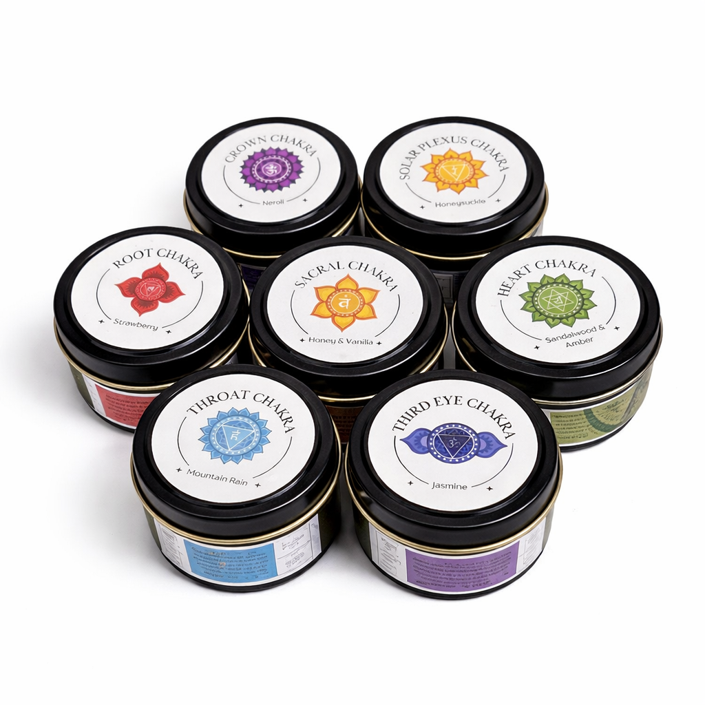 Set of seven tins with labels representing different chakras on a white background