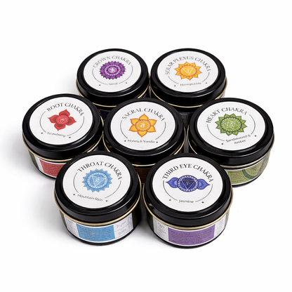 Set of seven tins with labels representing different chakras on a white background
