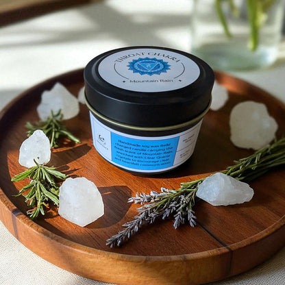 Throat Chakra Candle on a wooden tray with crystals and herbs