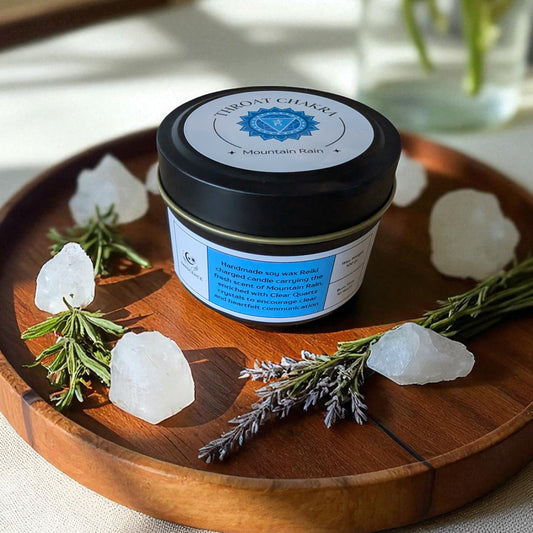 Throat Chakra Candle on a wooden tray with crystals and herbs